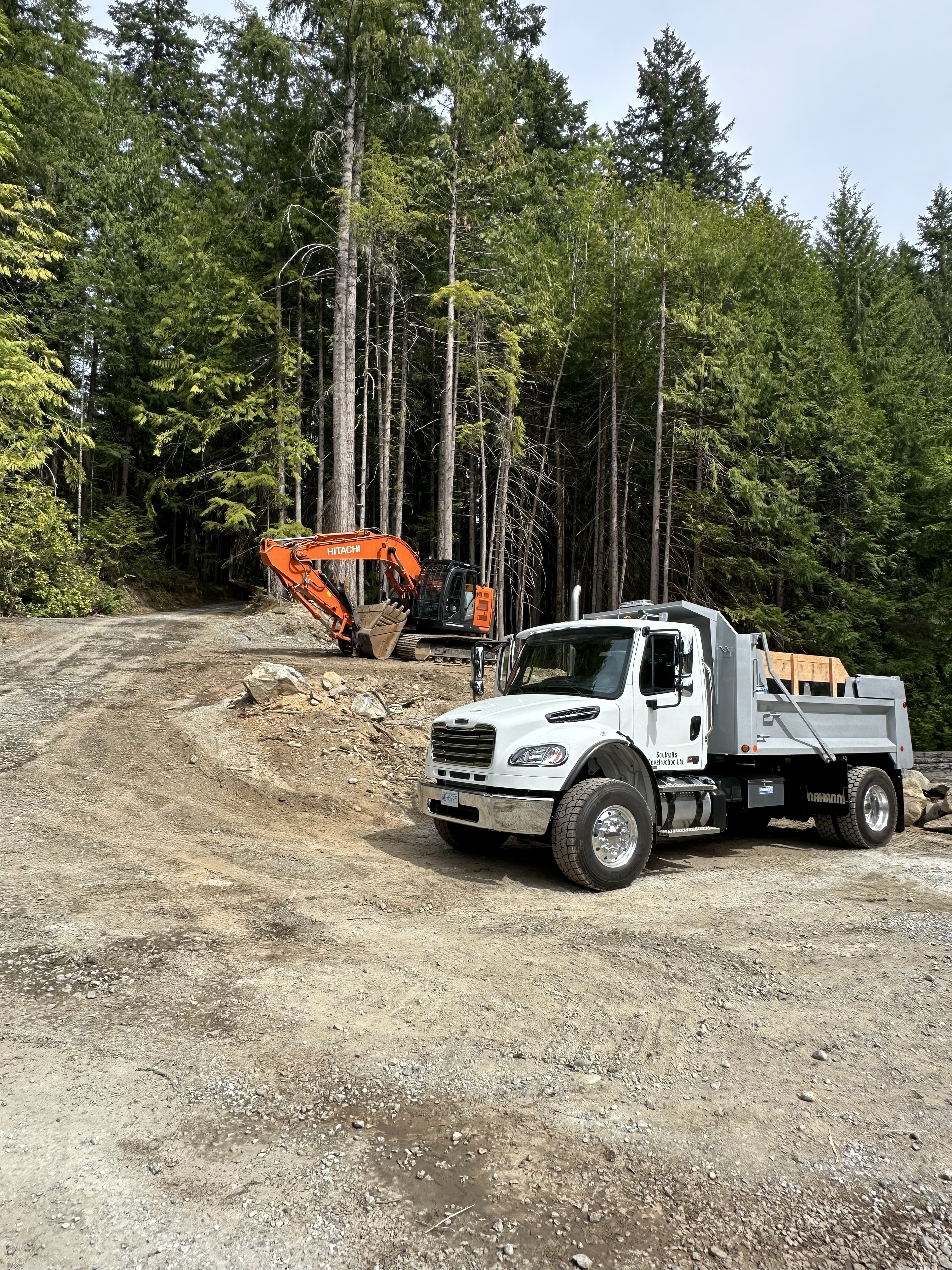 Hitachi 245 excavator and dump truck at Shawnigan Lake job site