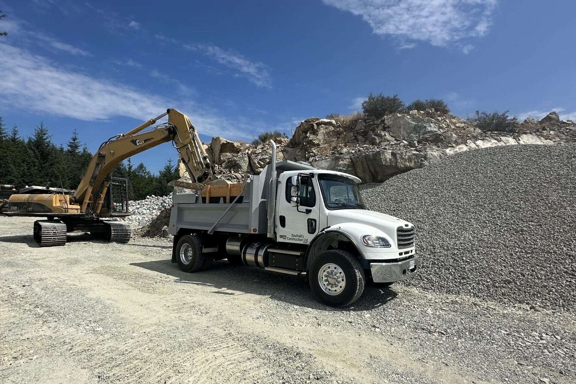 Single axle truck at quarry picking up rocks for Shawnigan site