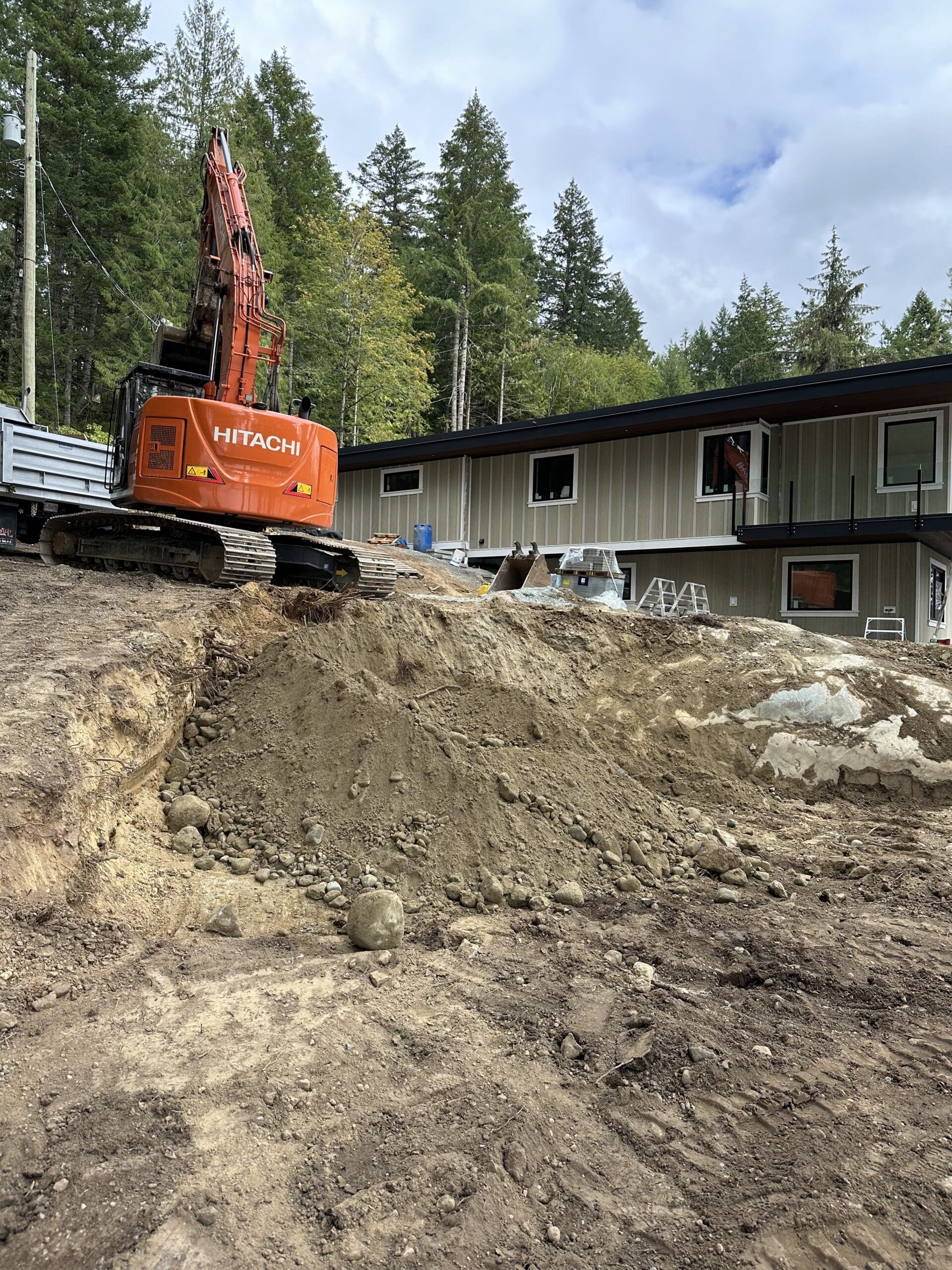 Hitachi 245 excavator clearing land at Shawnigan Lake construction site