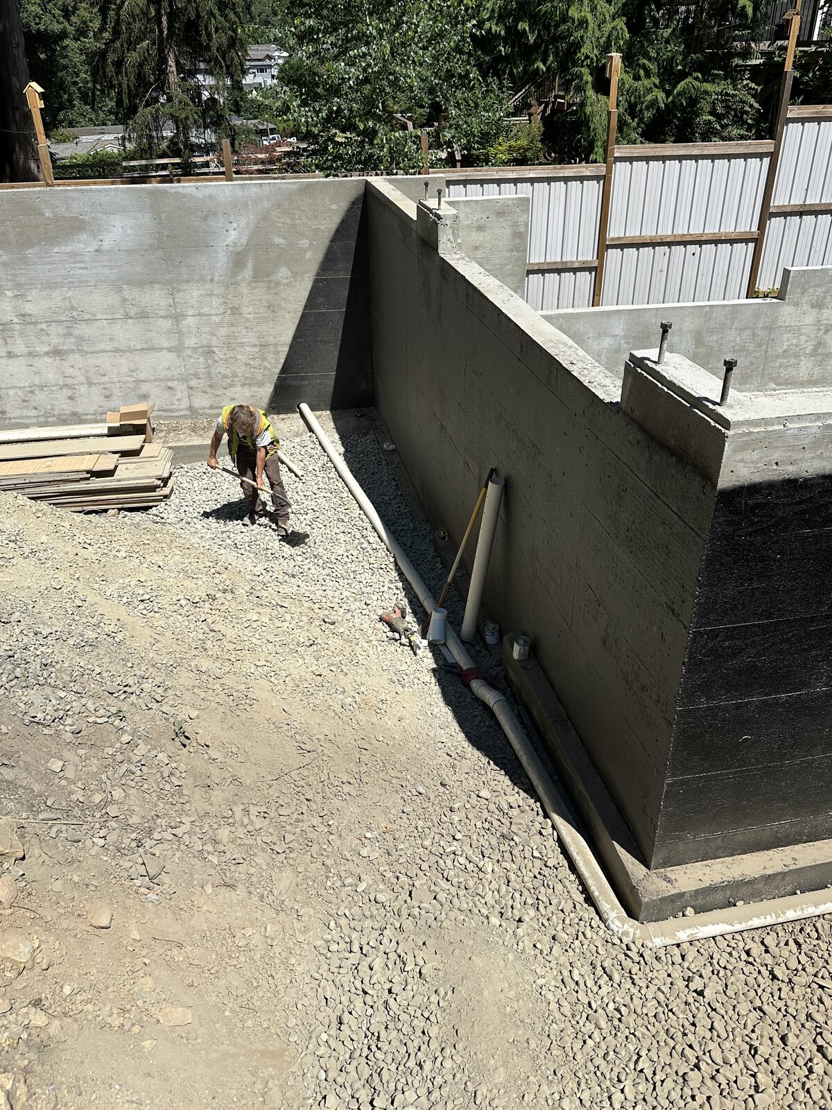 Coated foundation wall and perimeter gravel — garage addition and house underpinning project