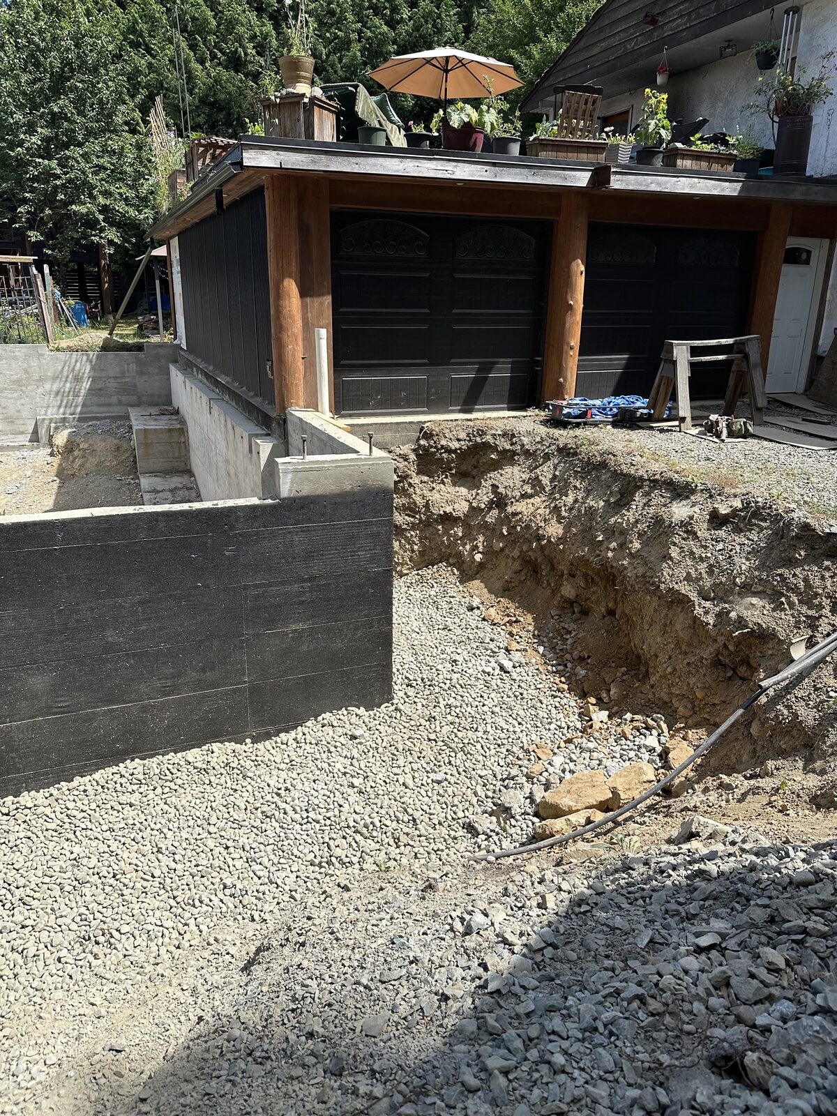 Garage foundation walls beside the existing house — garage addition and house underpinning project