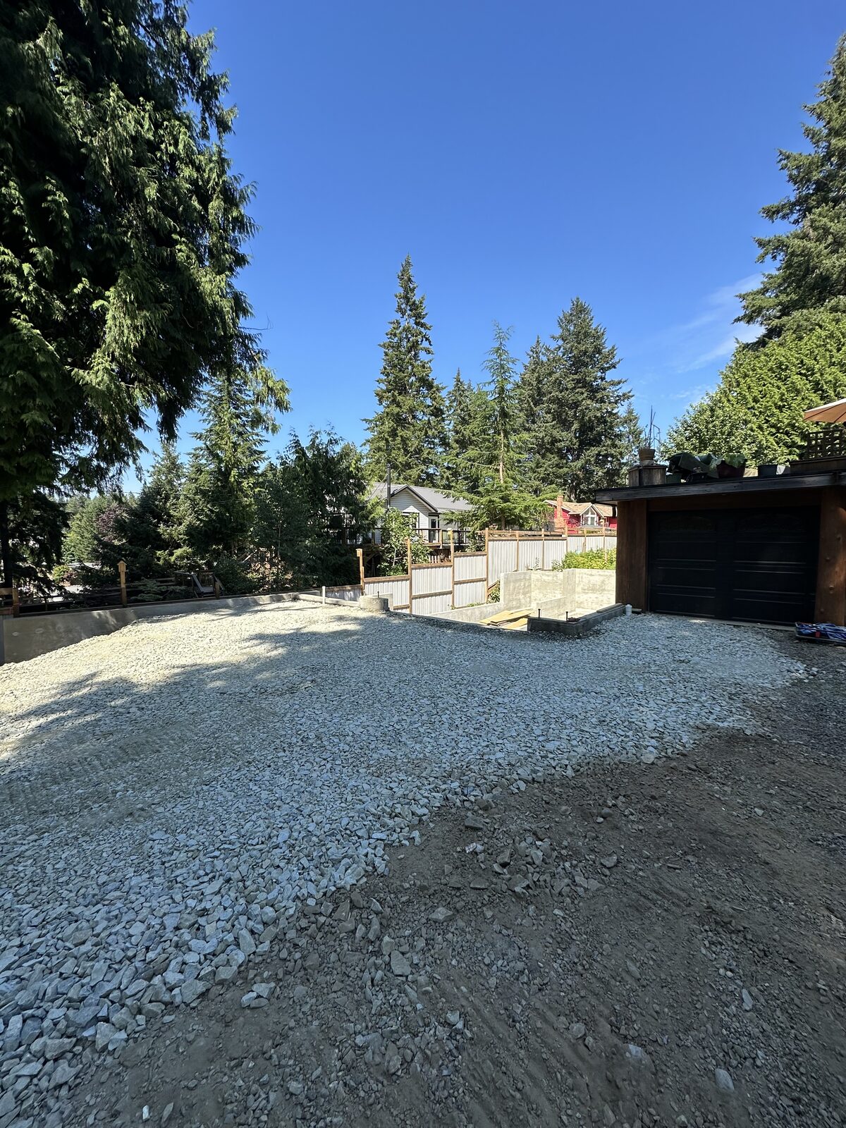 Gravel backfill around the garage addition foundation — garage addition and house underpinning project