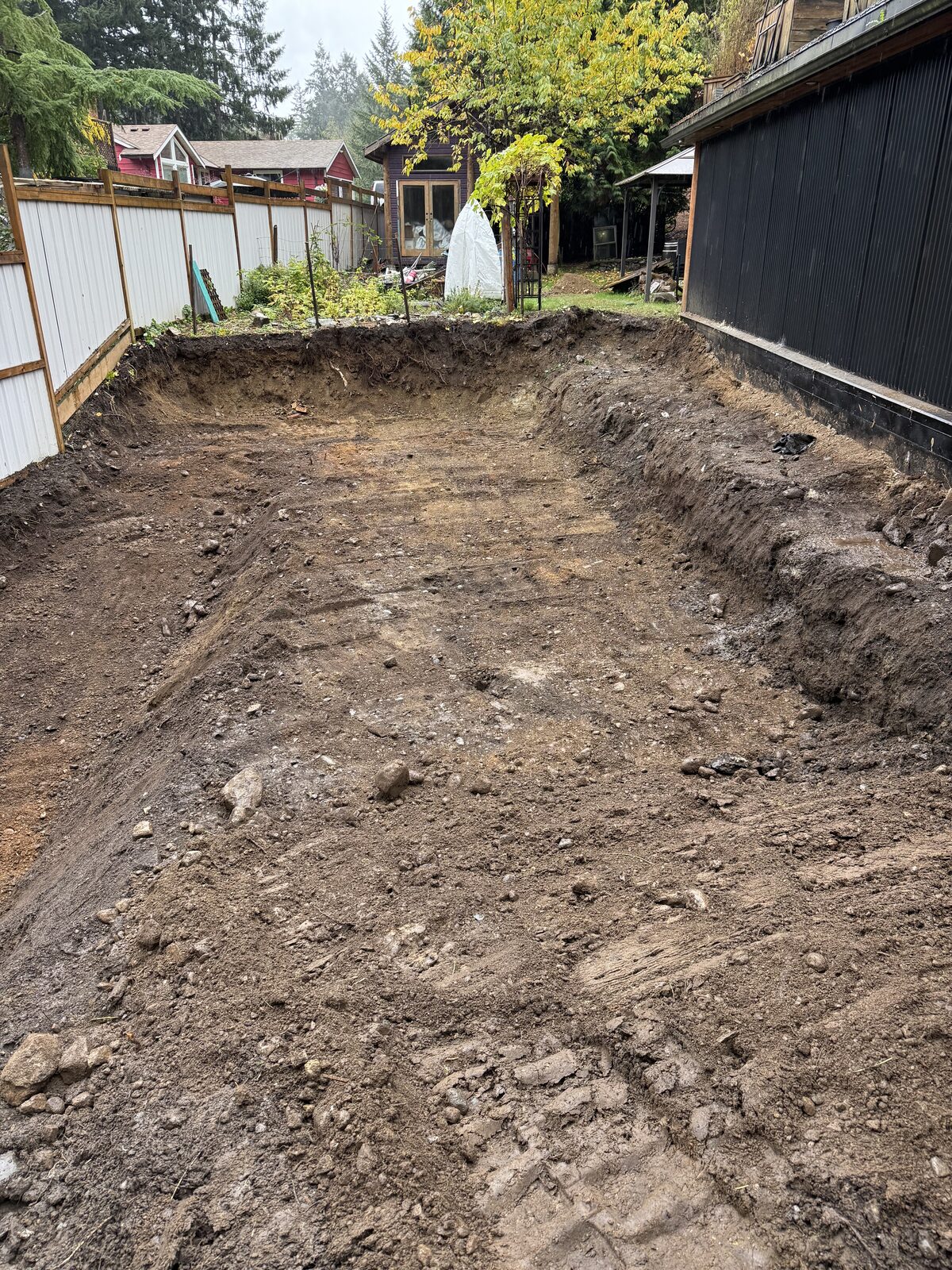Excavated area for the garage addition foundation — garage addition and house underpinning project