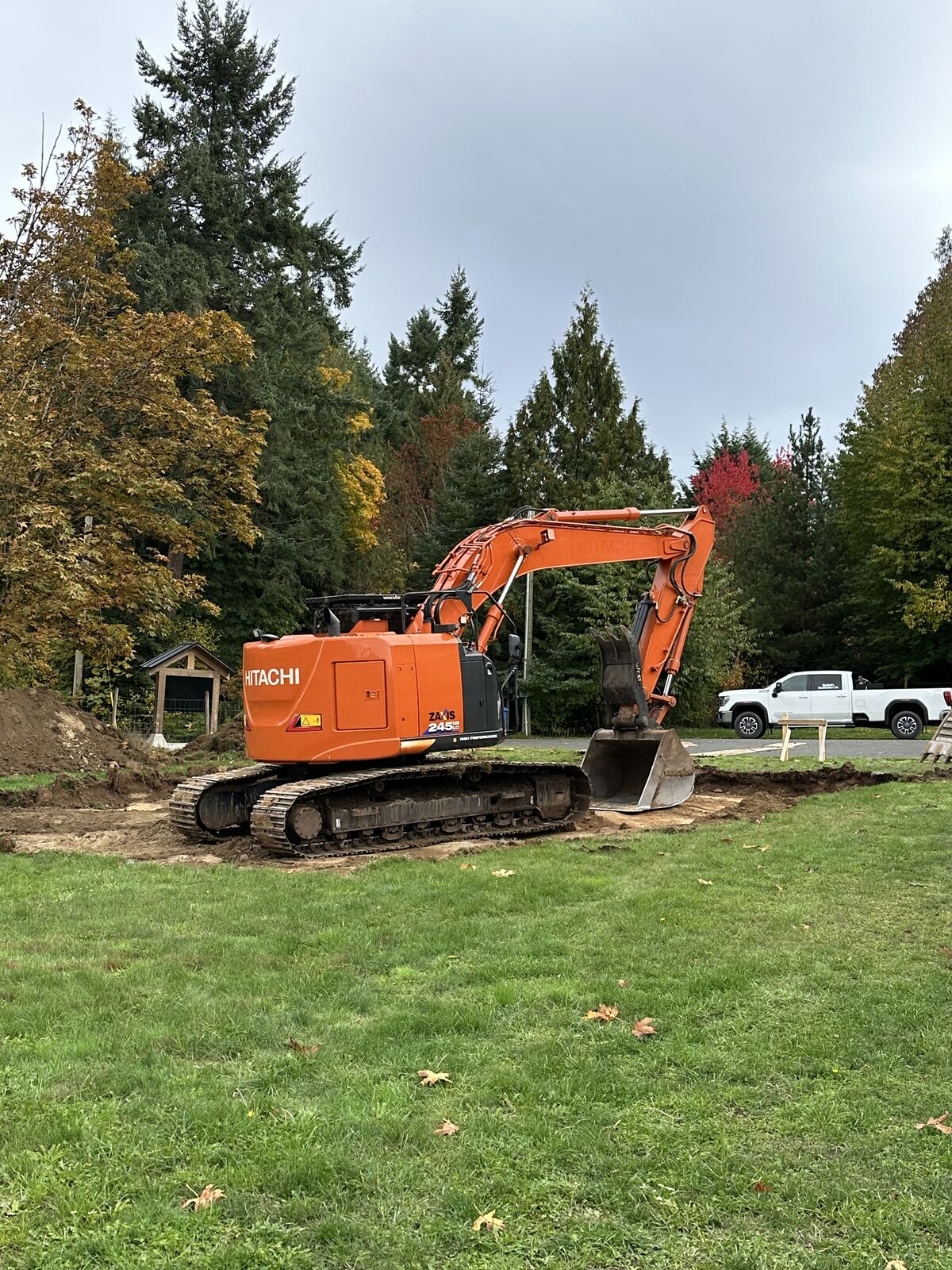 Excavator at the start of site work — Mill Bay excavation and foundation project