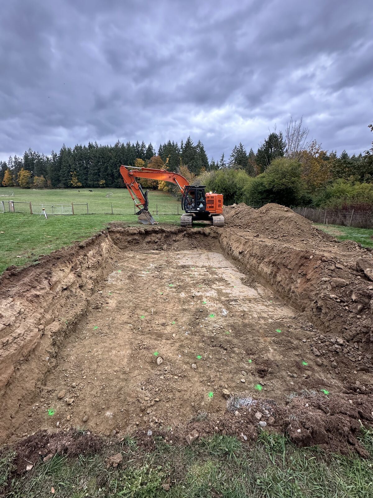 Excavator working across the foundation area — Mill Bay excavation and foundation project