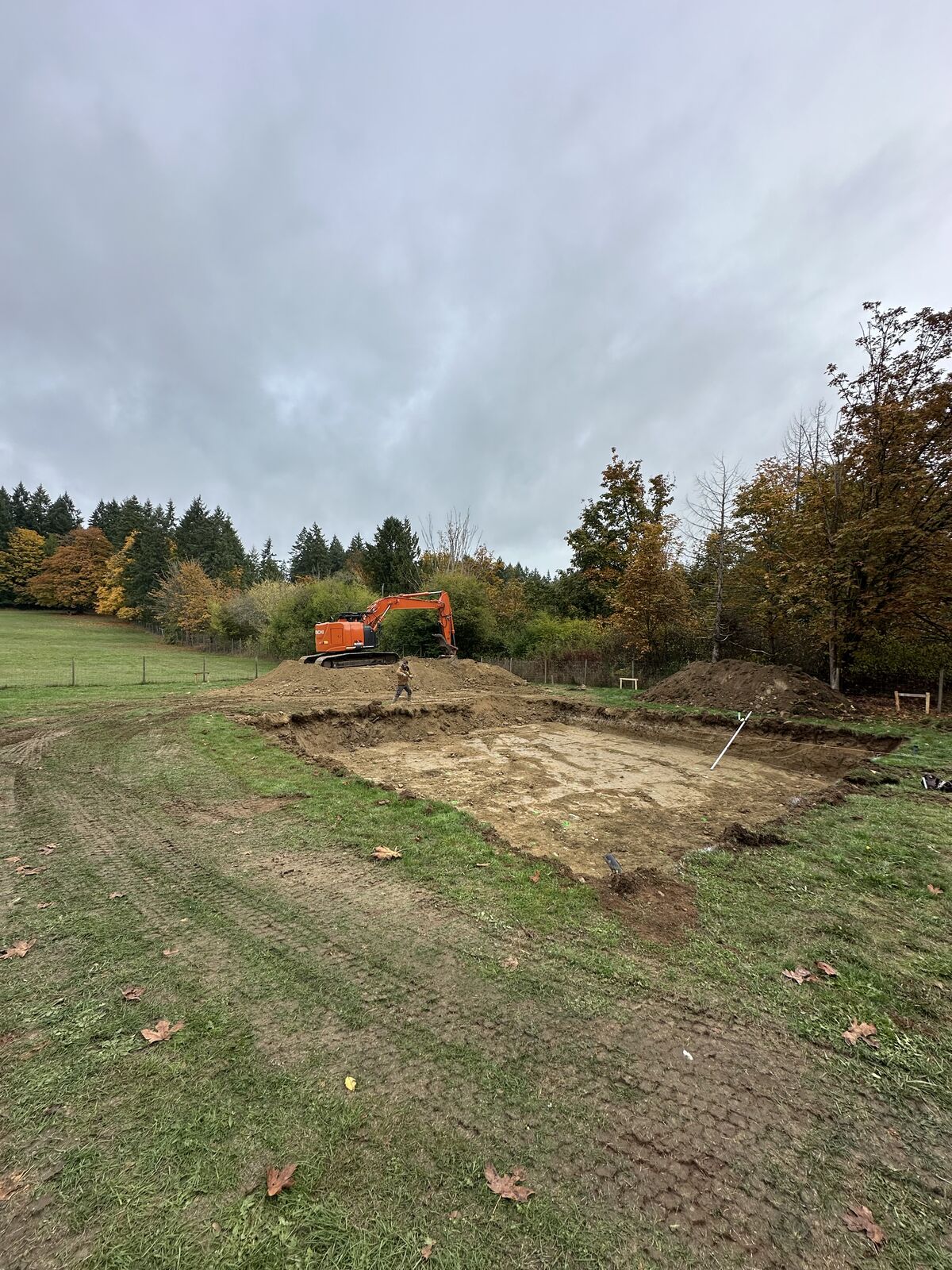 Excavation viewed from the surrounding lot — Mill Bay excavation and foundation project