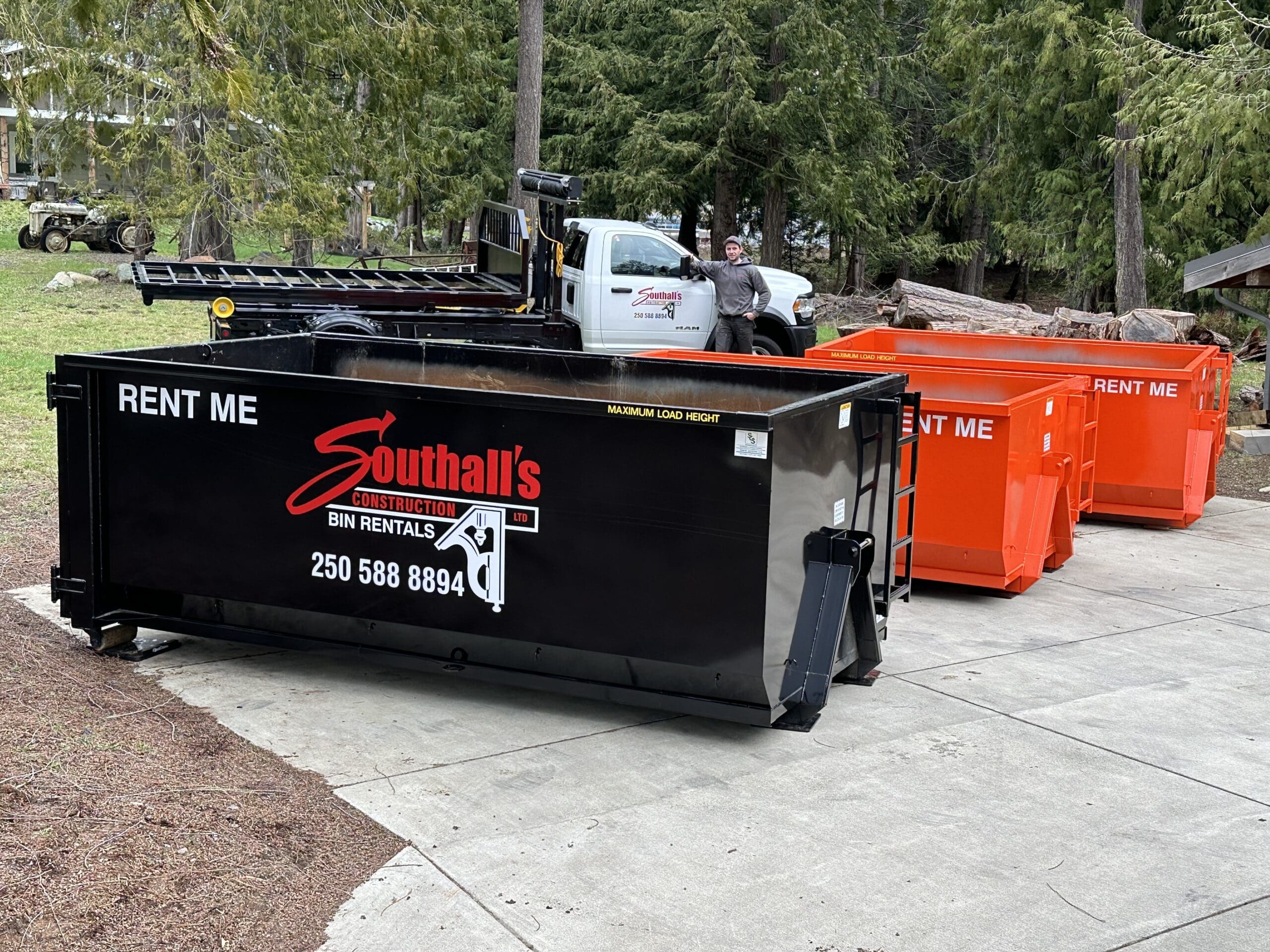 Black Southall Services waste bin positioned on a residential driveway for excavation and site cleanup