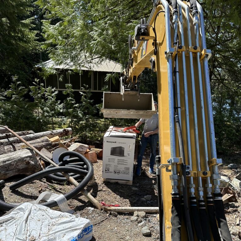 Professional excavation work preparing a residential property for construction in a wooded Cowichan Valley setting